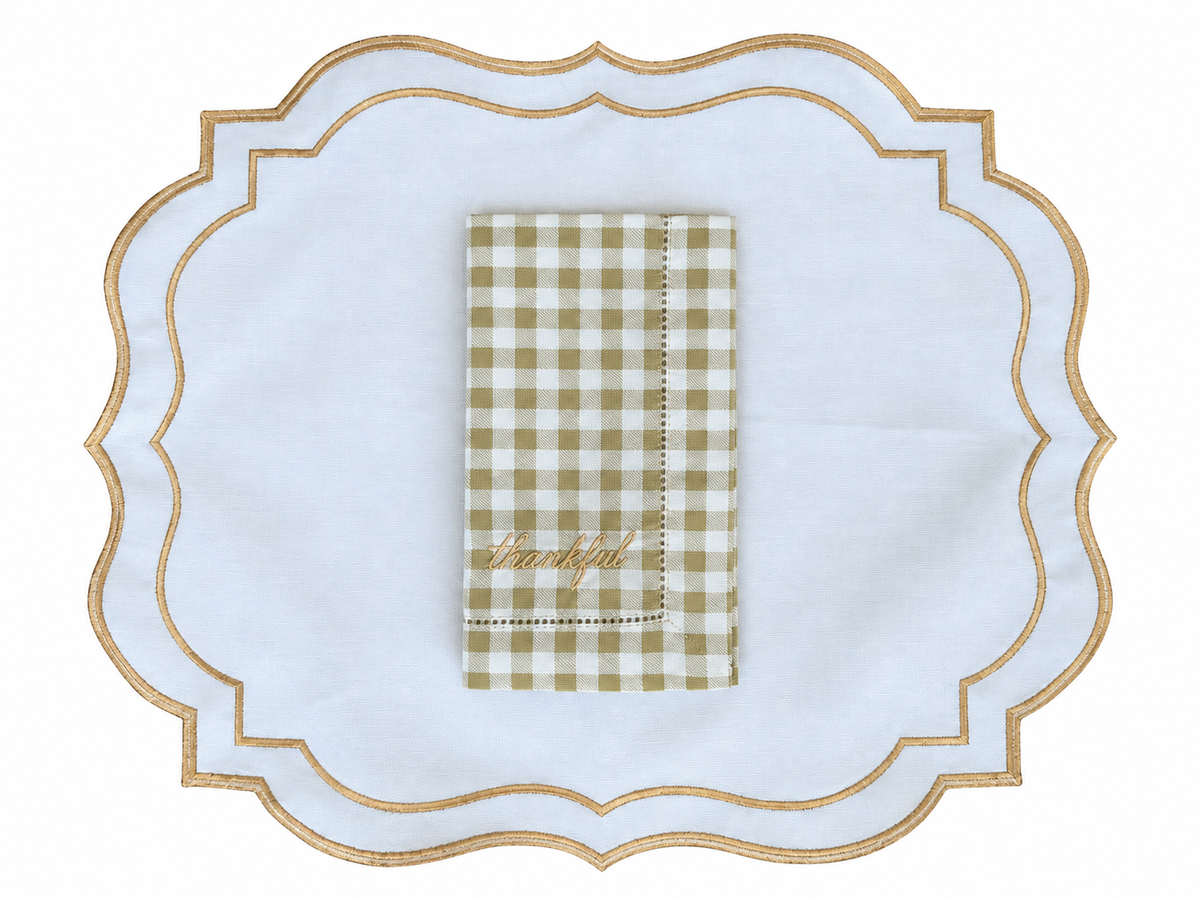Reversible plaid and white placemat with an embroidered napkin